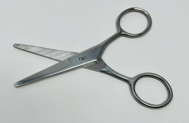 Pair of silver scissors on a white background