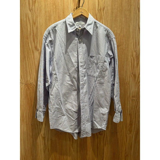 Striped shirt on a hanger against a wooden background