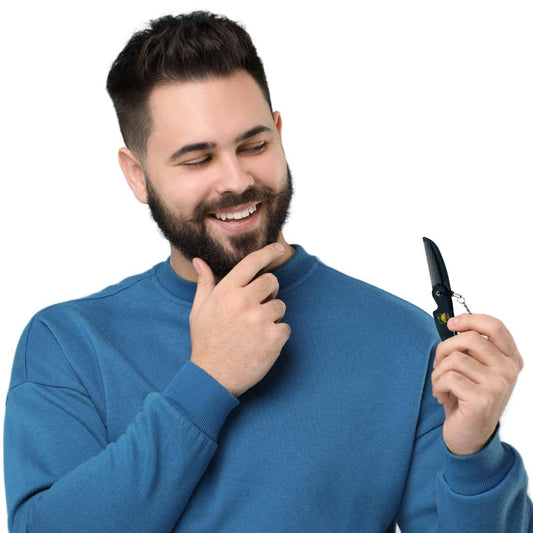 Man in a blue sweater holding a pocket knife against a white background