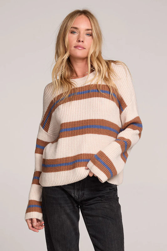 Woman wearing a striped sweater with a plain background