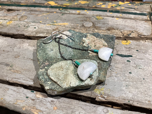 Earrings with natural stones on a wooden surface
