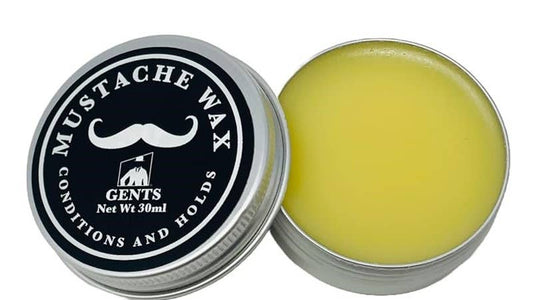 Mustache wax in a tin with a black lid featuring 'Gents' branding.