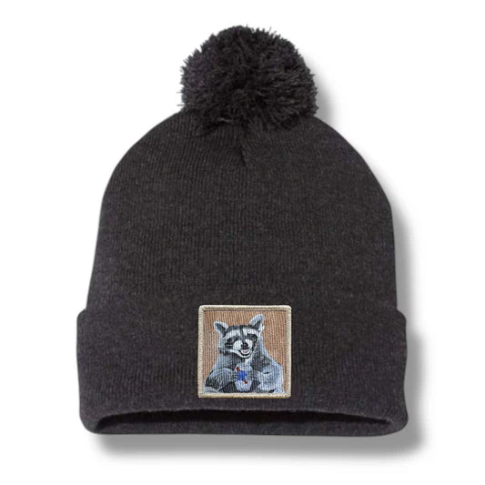 Dark gray beanie with a raccoon patch on a white background