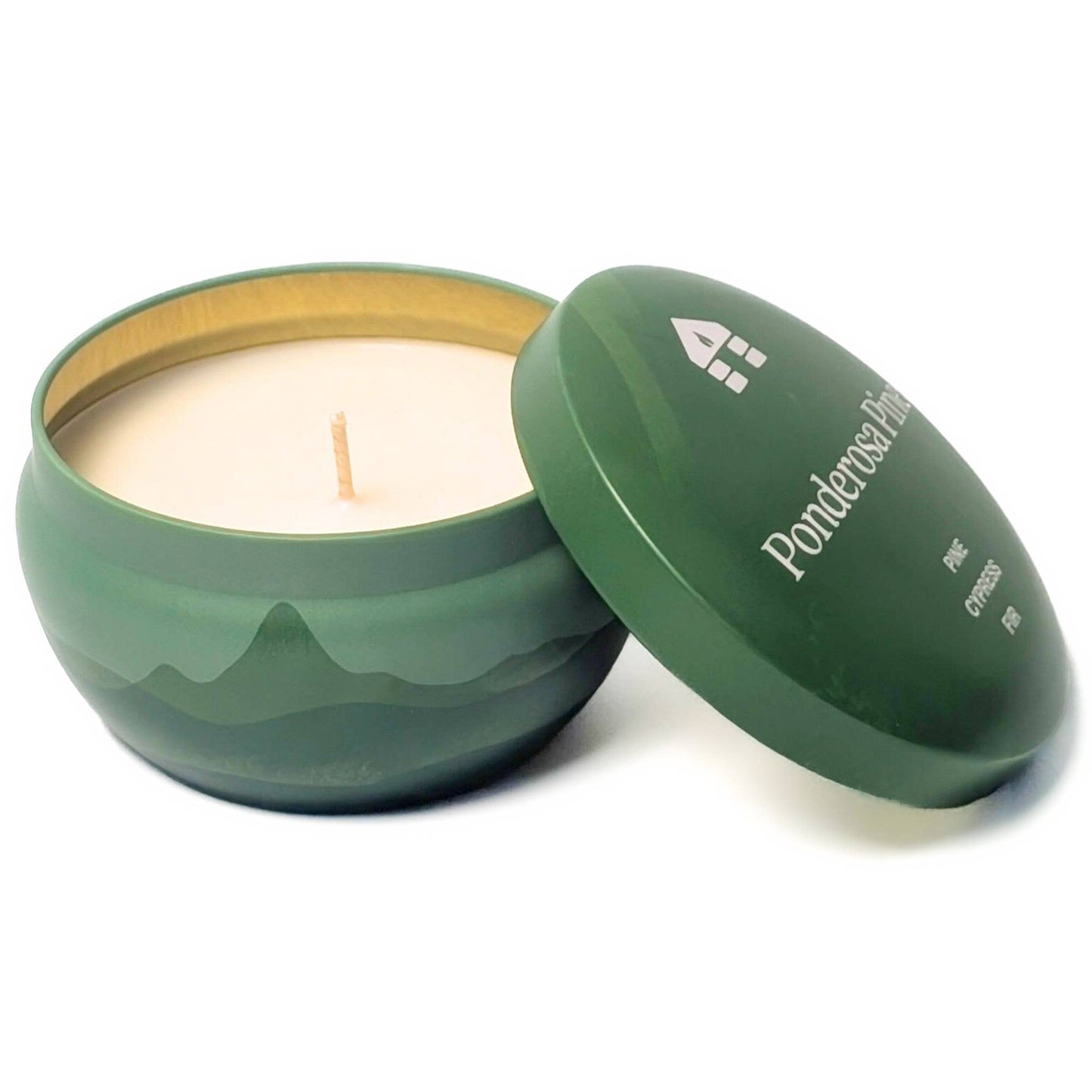 Green candle in a tin with lid on a white background