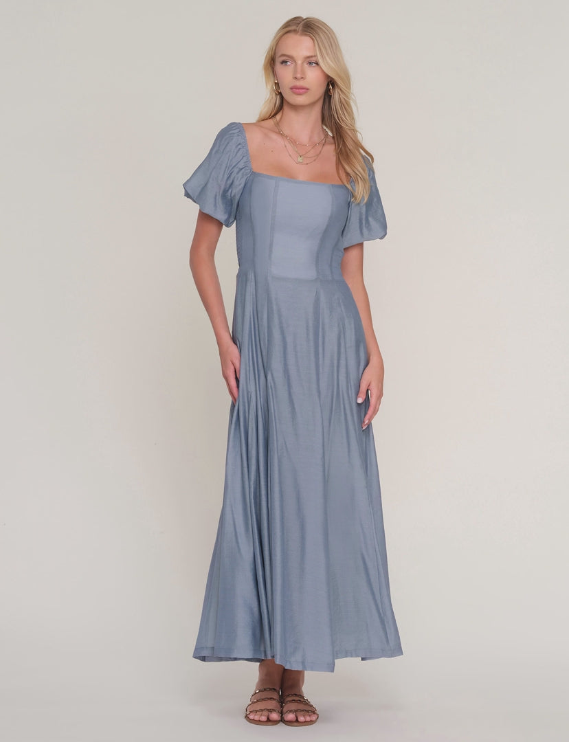 video of woman modeling blue dress on white background