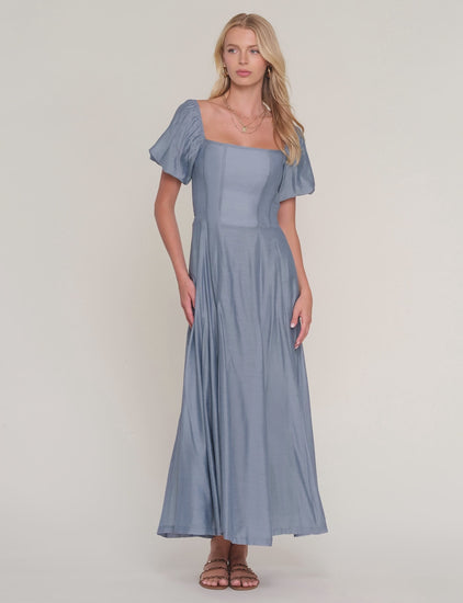 video of woman modeling blue dress on white background