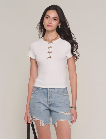 video of woman wearing white short sleeved top with bows