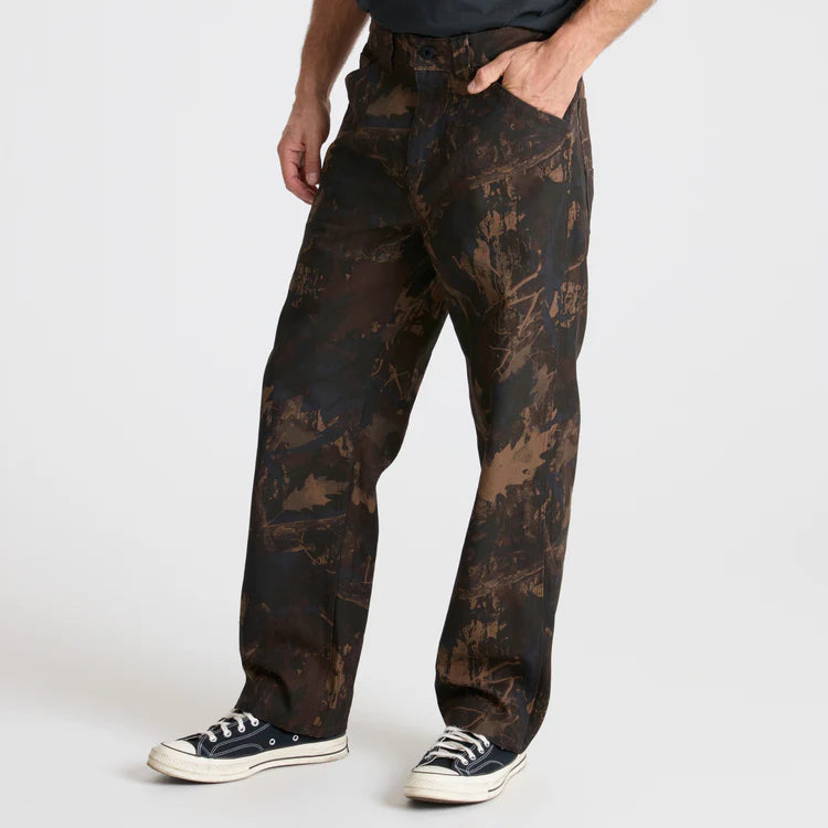 Camouflage pants worn by a person on a white background