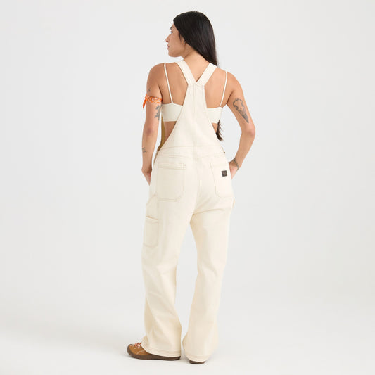 Person wearing a white overalls on a plain background