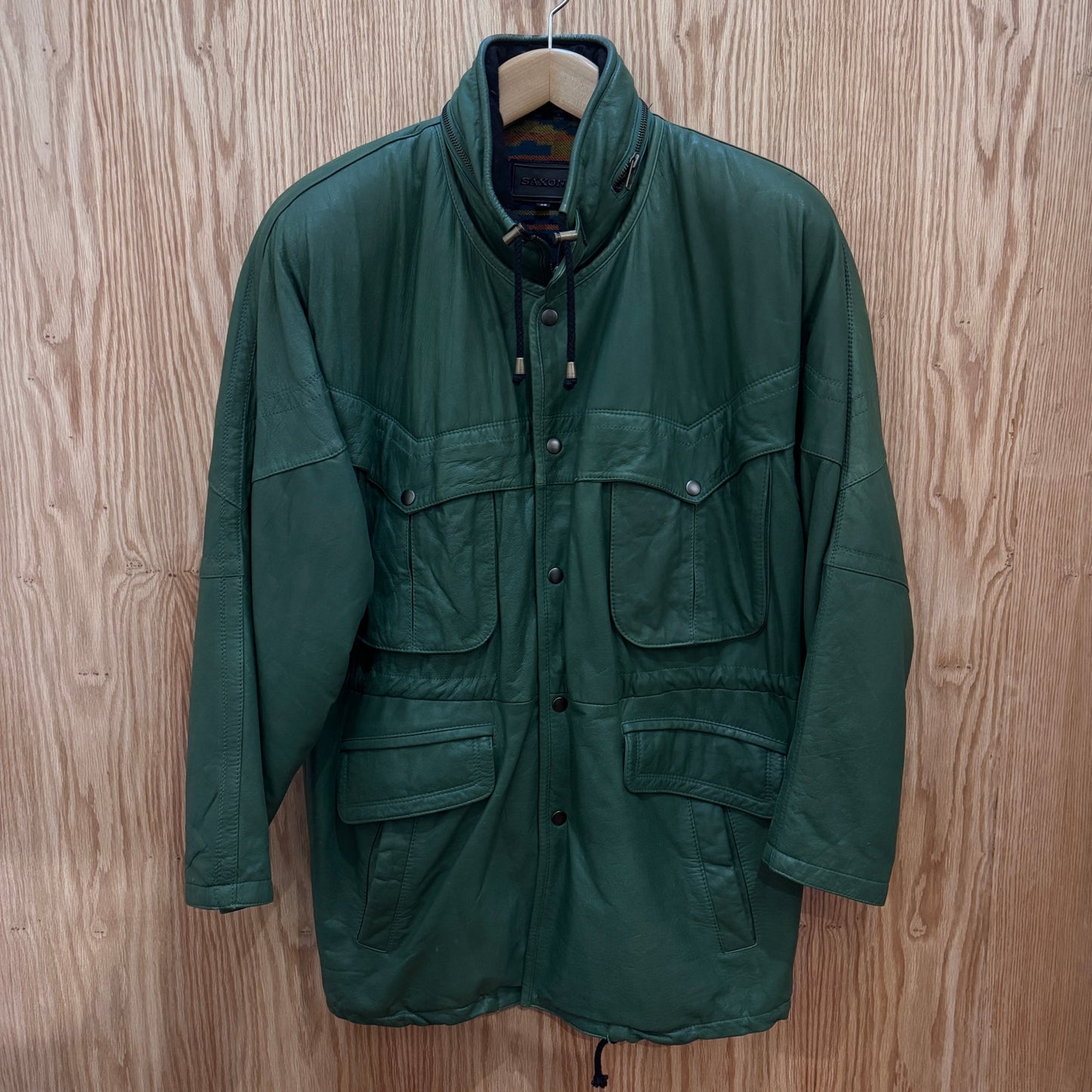 Green jacket on a wooden surface