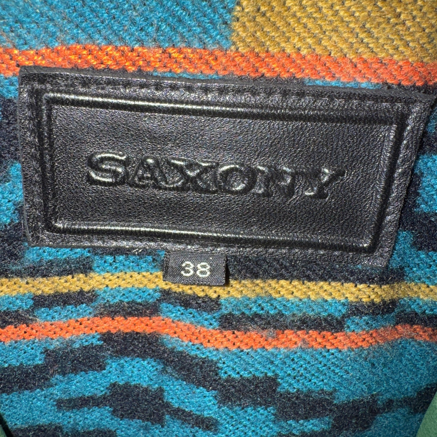 Black Saxony label on a colorful fabric background