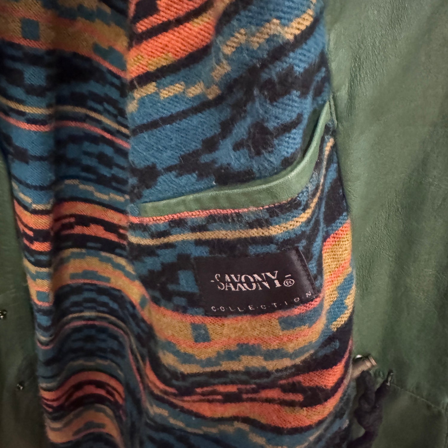 Multicolored patterned fabric with a brand logo on a green background