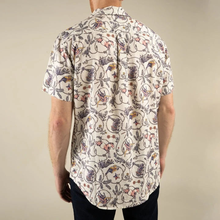 Person wearing a patterned shirt with a neutral background