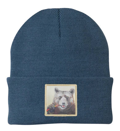 Blue beanie with a bear patch on a white background