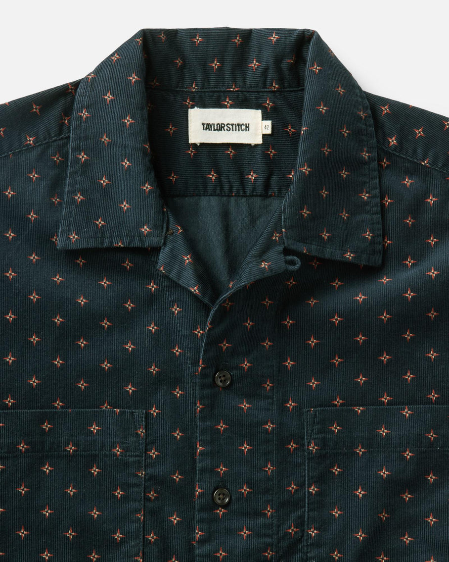 Dark green shirt with small pattern and 'Tailor Stitch' label on a white background