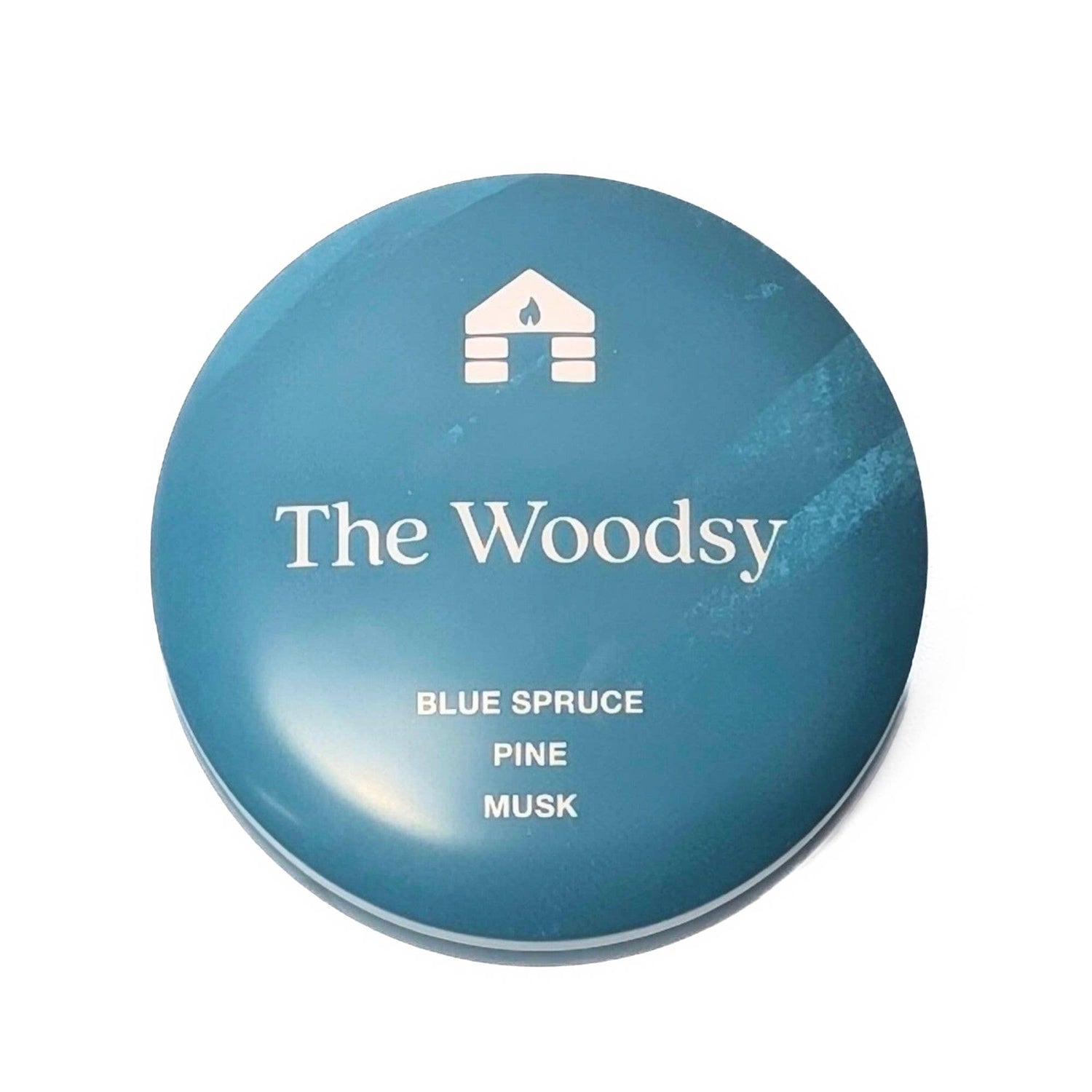 Blue container labeled 'The Woodsy' with notes on scents on a white background