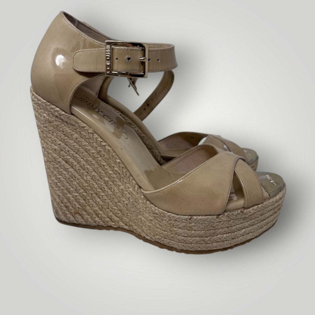 Beige wedge sandal with espadrille sole on a light gray background