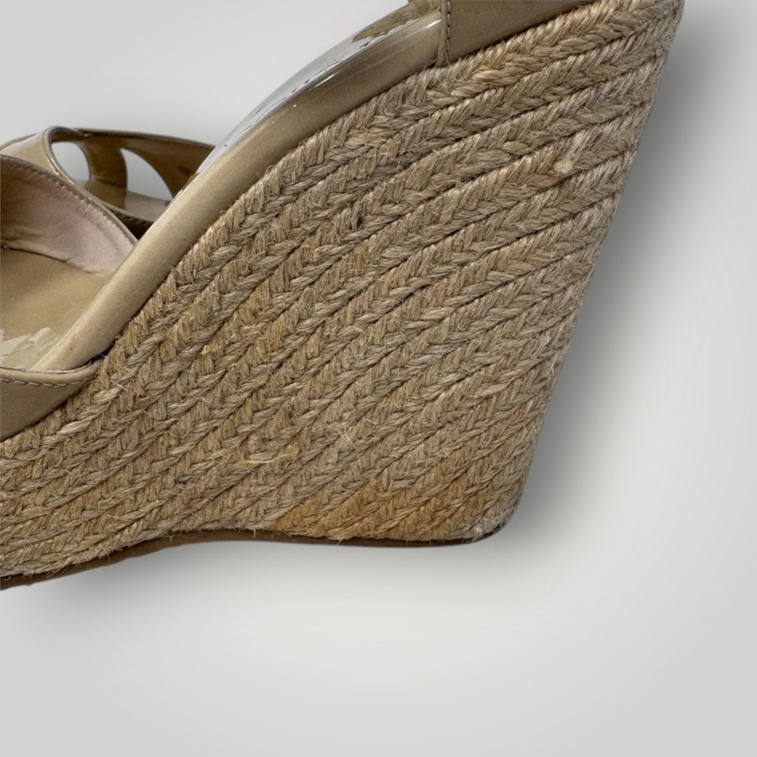 Close-up of a wedge sandal with espadrille sole on a light gray background